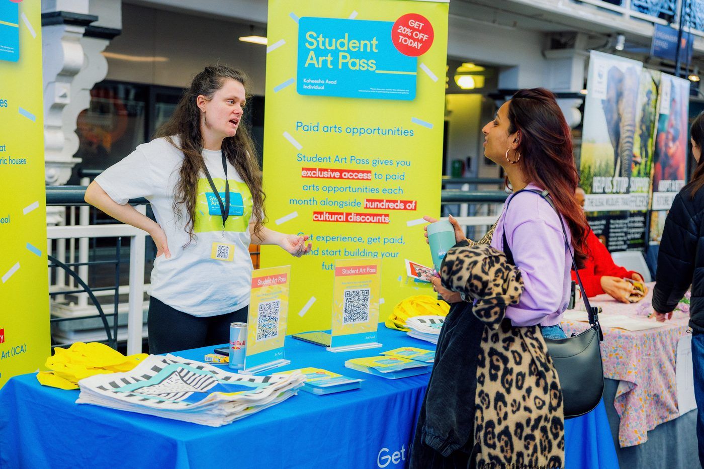 A native team member talking students through the stand at a campus fair