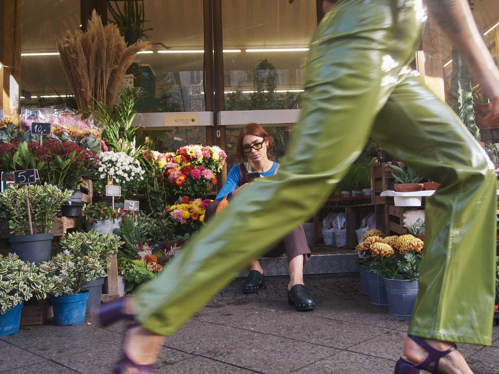 A student browsing flowers outside a local florist