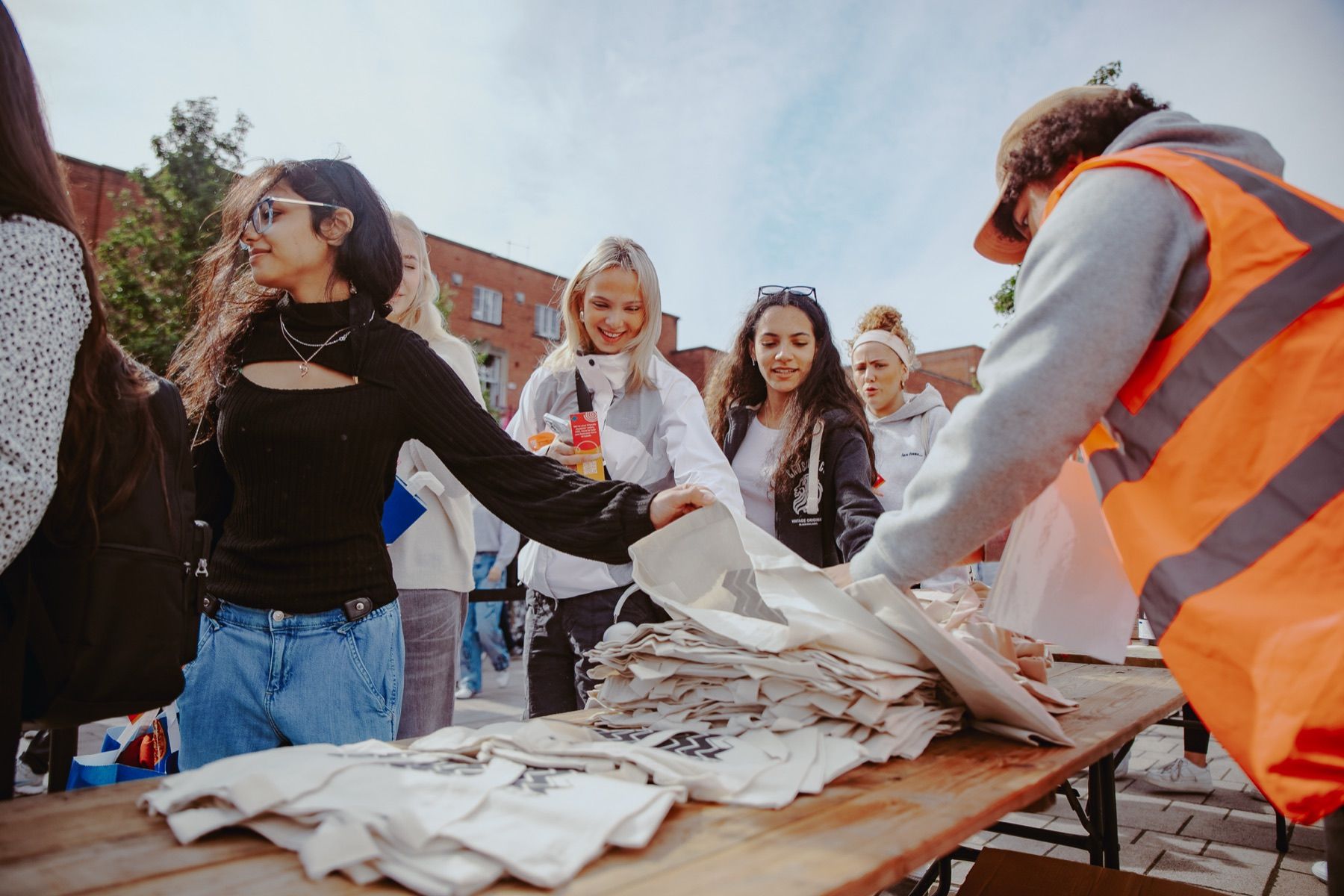 Students collecting tote bags at a campus activation